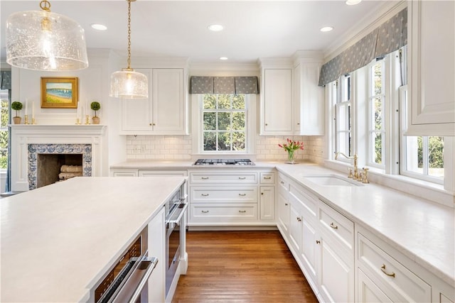 125 Grotto Ave, Providence, RI 02906 - kitchen with a sink, light countertops, white cabinets, tasteful backsplash, and recessed lighting