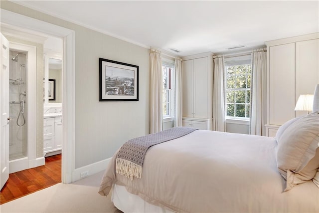 125 Grotto Ave, Providence, RI 02906 - bedroom featuring crown molding, baseboards, wood finished floors, and connected bathroom