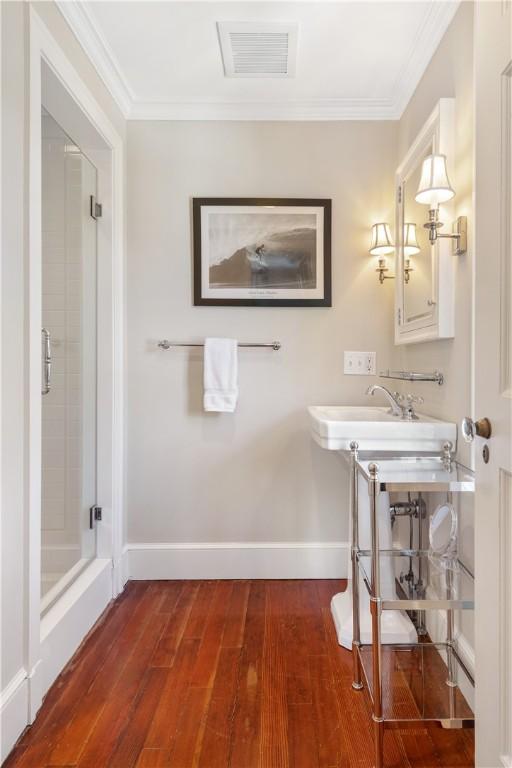 125 Grotto Ave, Providence, RI 02906 - full bathroom featuring wood finished floors, a stall shower, baseboards, and ornamental molding