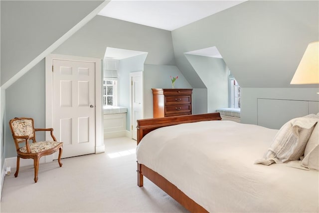 125 Grotto Ave, Providence, RI 02906 - bedroom featuring light colored carpet, lofted ceiling, and connected bathroom