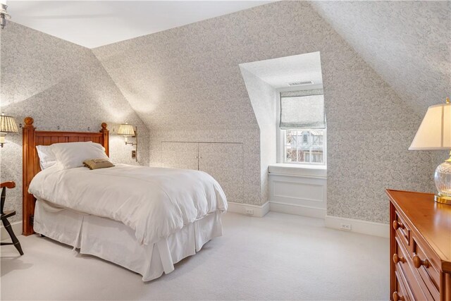 125 Grotto Ave, Providence, RI 02906 - bedroom with light carpet, wallpapered walls, and lofted ceiling