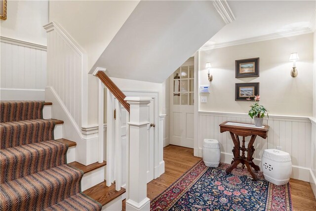 125 Grotto Ave, Providence, RI 02906 - stairs with wood finished floors, wainscoting, ornamental molding, and a decorative wall
