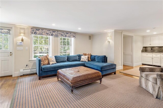 125 Grotto Ave, Providence, RI 02906 - living area with a baseboard radiator, light wood-style flooring, recessed lighting, baseboards, and crown molding