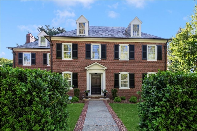 125 Grotto Ave, Providence, RI 02906 - colonial house with brick siding, a chimney, and a front yard