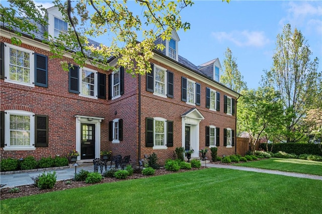 125 Grotto Ave, Providence, RI 02906 - colonial house with a front yard and brick siding