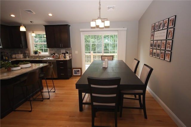 dining space featuring light wood-type flooring and recessed lighting