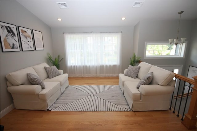living room featuring a chandelier, wood finished floors, recessed lighting, and baseboards