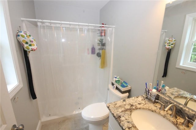 full bath with a stall shower, vanity, and toilet