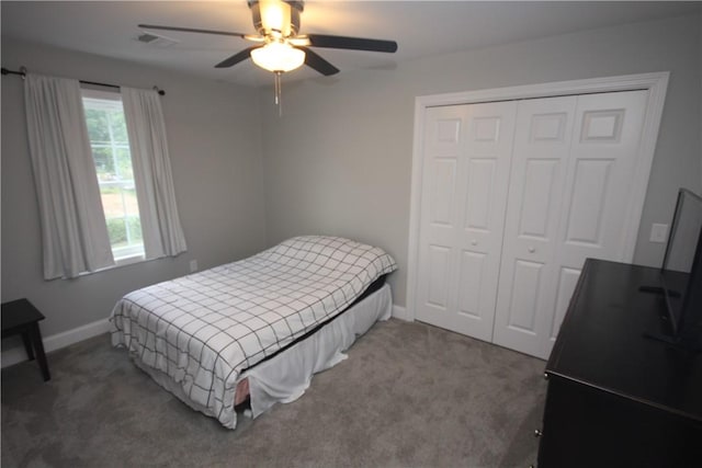 carpeted bedroom featuring a closet, baseboards, and a ceiling fan
