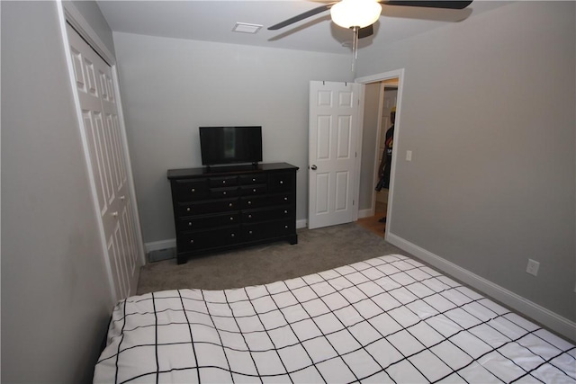 carpeted bedroom with a closet, a ceiling fan, and baseboards