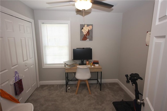 carpeted office with a ceiling fan, plenty of natural light, and baseboards
