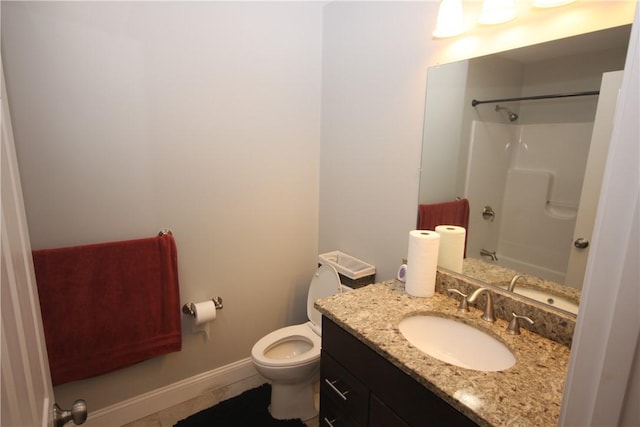 full bathroom with toilet, vanity, and baseboards