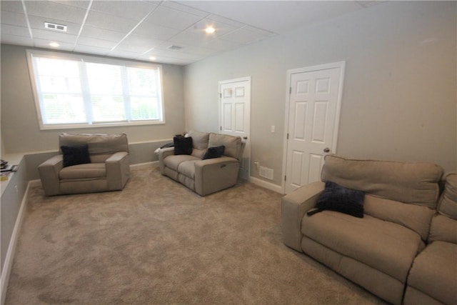 living room with carpet floors, baseboards, and a drop ceiling