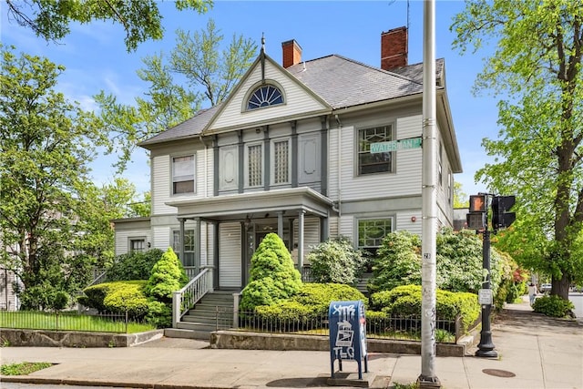 view of front of house with a porch and a chimney