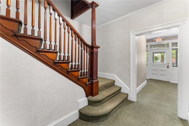 staircase featuring ornamental molding, baseboards, and carpet floors