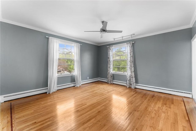 unfurnished room featuring plenty of natural light, wood finished floors, ceiling fan, ornamental molding, and a baseboard radiator