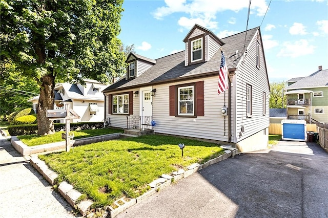 new england style home with a front yard