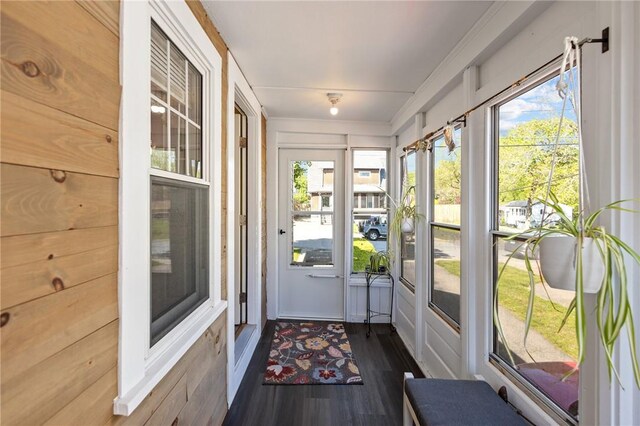 sunroom / solarium featuring wood finished floors
