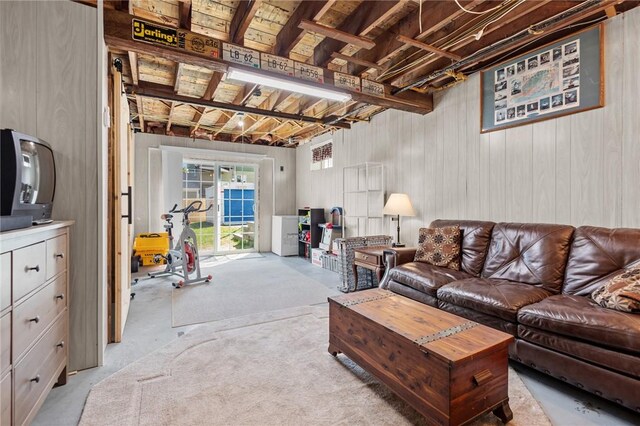 living area with wood walls and concrete flooring