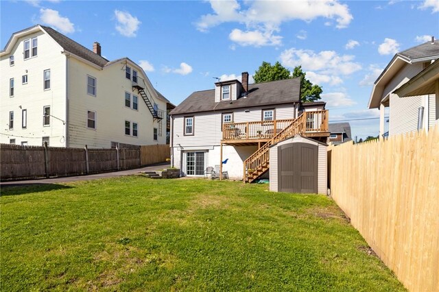 back of property featuring a storage unit, an outdoor structure, a deck, a chimney, and stairway