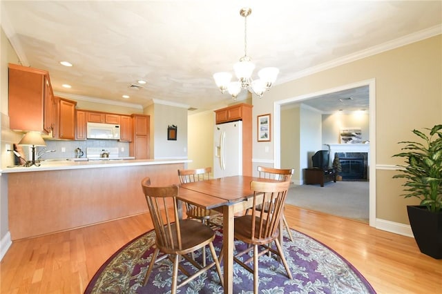 200 Roger Williams Ave Unit 106, East Providence, RI 02916 - dining area featuring a chandelier, a glass covered fireplace, light wood finished floors, recessed lighting, and baseboards