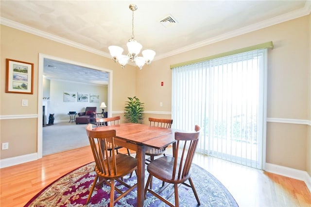 200 Roger Williams Ave Unit 106, East Providence, RI 02916 - dining space featuring plenty of natural light, a chandelier, wood finished floors, crown molding, and baseboards