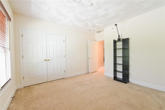 200 Roger Williams Ave Unit 106, East Providence, RI 02916 - unfurnished bedroom featuring light colored carpet, baseboards, and a closet
