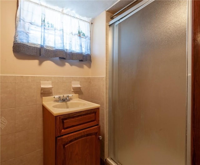 49 Gooding St, Pawtucket, RI 02860 - full bathroom featuring a shower stall, tile walls, vanity, and a wainscoted wall