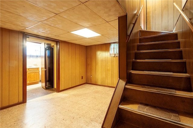 49 Gooding St, Pawtucket, RI 02860 - finished basement with light flooring, baseboards, wood walls, and stairs