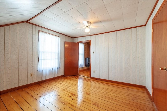 49 Gooding St, Pawtucket, RI 02860 - empty room with hardwood / wood-style flooring, wood walls, ceiling fan, ornamental molding, and baseboards