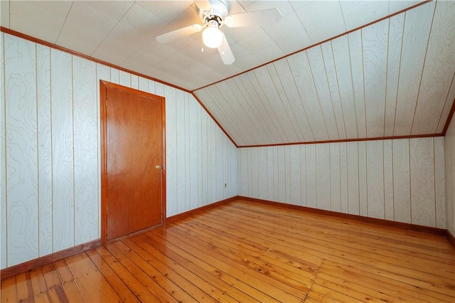 49 Gooding St, Pawtucket, RI 02860 - additional living space with hardwood / wood-style flooring, wood walls, a ceiling fan, vaulted ceiling, and baseboards