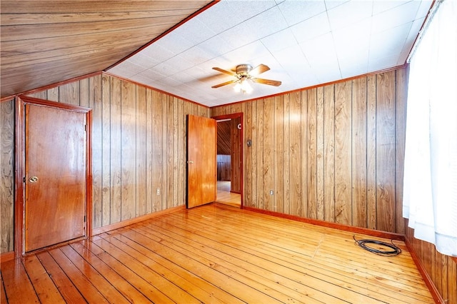 49 Gooding St, Pawtucket, RI 02860 - empty room featuring hardwood / wood-style floors, wood walls, and ceiling fan