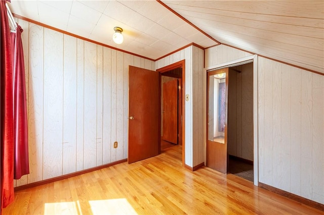 49 Gooding St, Pawtucket, RI 02860 - unfurnished bedroom with wood finished floors, wooden walls, baseboards, lofted ceiling, and crown molding