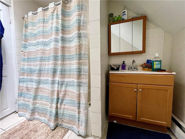 bathroom with lofted ceiling, tile walls, and vanity