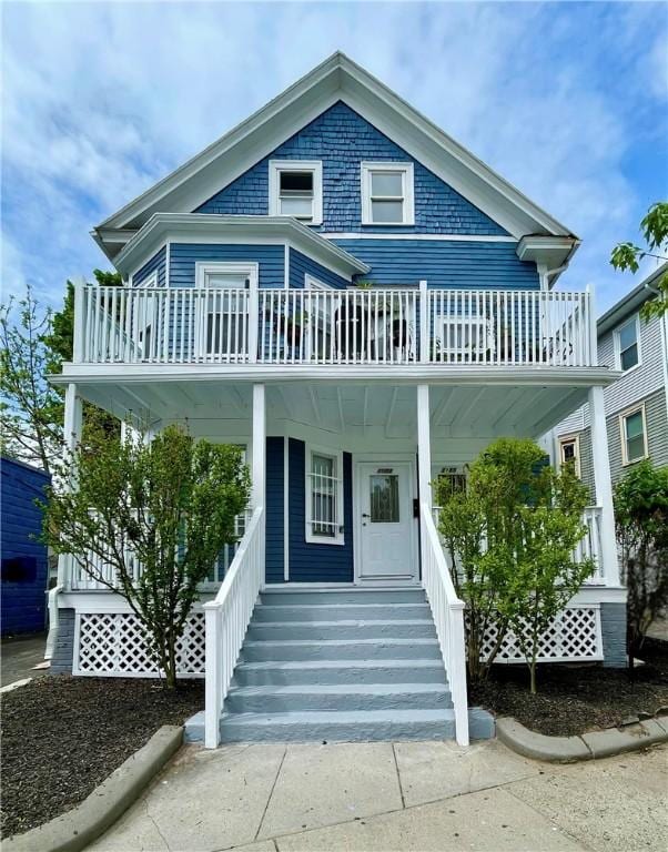 view of front of property with a porch and a balcony