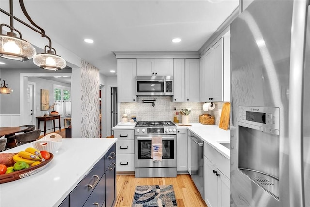1 Fried Ave, Bristol, RI 02809 - kitchen featuring stainless steel appliances, light countertops, light wood-type flooring, backsplash, and recessed lighting