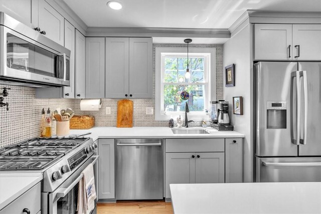 1 Fried Ave, Bristol, RI 02809 - kitchen featuring stainless steel appliances, a sink, gray cabinets, decorative backsplash, and light countertops