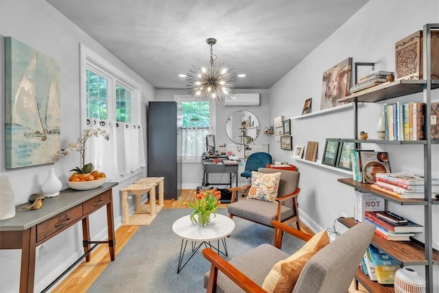 1 Fried Ave, Bristol, RI 02809 - living area featuring light wood finished floors, a chandelier, a wall unit AC, baseboards, and recessed lighting
