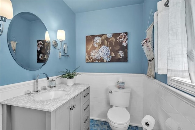 1 Fried Ave, Bristol, RI 02809 - bathroom featuring a wainscoted wall, vanity, toilet, tile walls, and tile patterned flooring