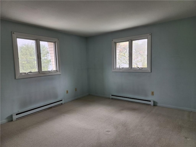 29 School St Unit 12E, Westerly, RI 02891 - carpeted empty room with a baseboard heating unit and baseboards