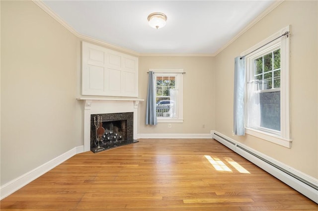 110 Narragansett Ave W, South Kingstown, RI 02879 - unfurnished living room featuring a baseboard radiator, light wood-type flooring, a premium fireplace, plenty of natural light, and crown molding