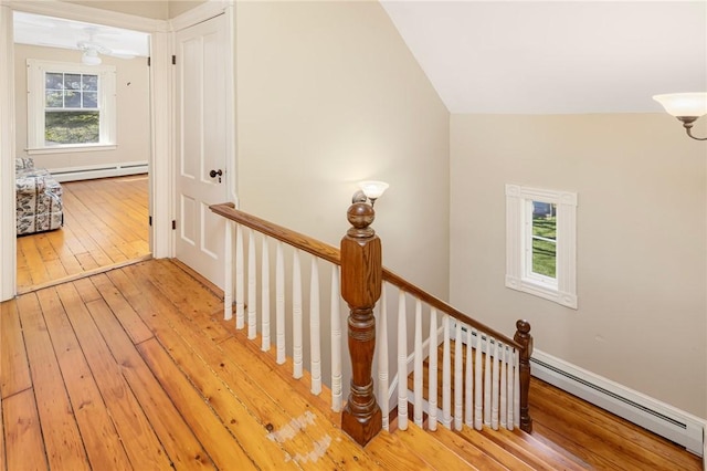 110 Narragansett Ave W, South Kingstown, RI 02879 - stairs with hardwood / wood-style flooring, baseboard heating, and a chandelier