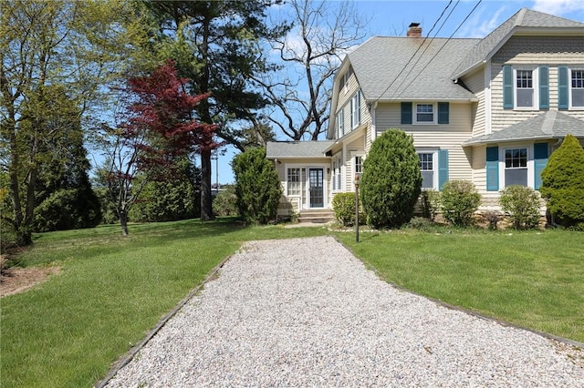 110 Narragansett Ave W, South Kingstown, RI 02879 - view of front facade featuring a chimney, roof with shingles, and a front lawn