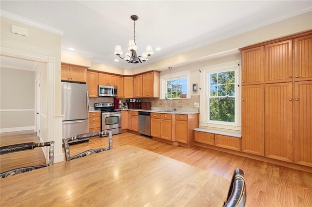 110 Narragansett Ave W, South Kingstown, RI 02879 - kitchen with appliances with stainless steel finishes, a sink, a chandelier, light countertops, and decorative backsplash