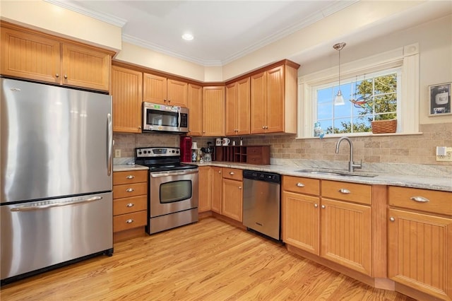 110 Narragansett Ave W, South Kingstown, RI 02879 - kitchen featuring stainless steel appliances, a sink, light wood-type flooring, light stone counters, and crown molding