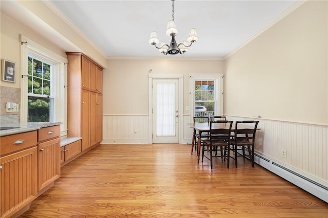 110 Narragansett Ave W, South Kingstown, RI 02879 - dining space featuring a baseboard heating unit, light wood finished floors, a chandelier, healthy amount of natural light, and wainscoting