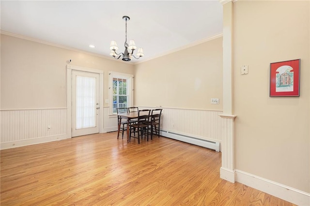 110 Narragansett Ave W, South Kingstown, RI 02879 - dining space featuring a baseboard heating unit, a chandelier, ornamental molding, wood finished floors, and wainscoting