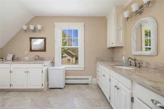 110 Narragansett Ave W, South Kingstown, RI 02879 - full bathroom with a baseboard heating unit, two vanities, healthy amount of natural light, vaulted ceiling, and tile patterned floors