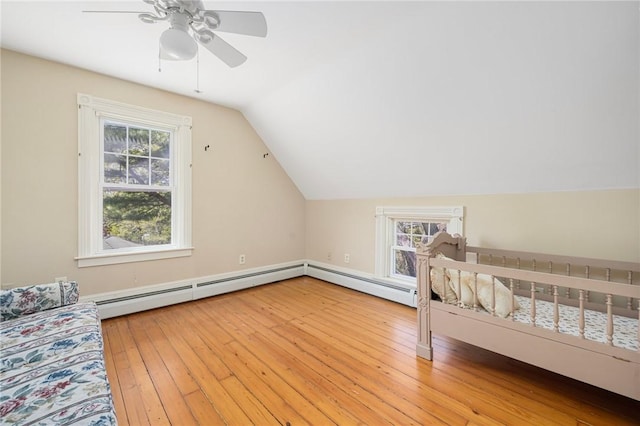 110 Narragansett Ave W, South Kingstown, RI 02879 - bedroom with vaulted ceiling, hardwood / wood-style flooring, a baseboard heating unit, and a ceiling fan