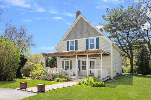 110 Narragansett Ave W, South Kingstown, RI 02879 - rear view of house with a porch, a lawn, and a chimney
